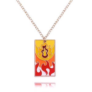 May include: A gold-tone chain necklace with a rectangular pendant depicting a flame design. The pendant has a yellow background with orange and red flames. A fashionable accessory.