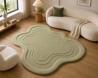 Alfombra verde con forma orgánica, alfombra moderna con mechones, alfombra abstracta de ondas color salvia.