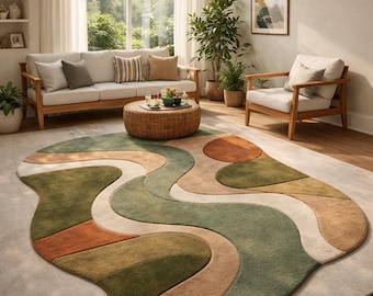 May include: An area rug featuring an organic, irregular shape with a wavy, abstract pattern. The design consists of flowing, curved sections in shades of sage green, muted olive, warm beige, cream, and burnt orange, creating a layered, textured look.