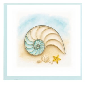 May include: A greeting card featuring a detailed illustration of a nautilus shell, seashells, and a starfish on a sandy beach with a blue watercolor sky. The card has a light blue border.