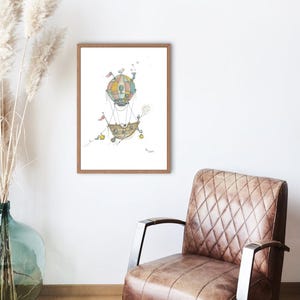 May include: A framed watercolor print of a whimsical hot air balloon with a colorful striped top and a detailed basket. The artwork is displayed on a white wall, next to a brown leather armchair and a vase with dried plants.