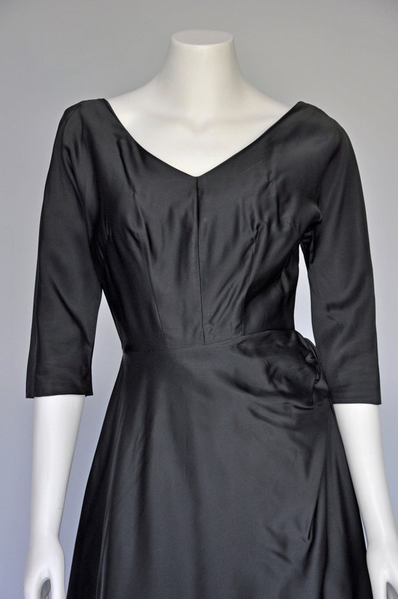 vintage 1950s black satin party dress with side bo