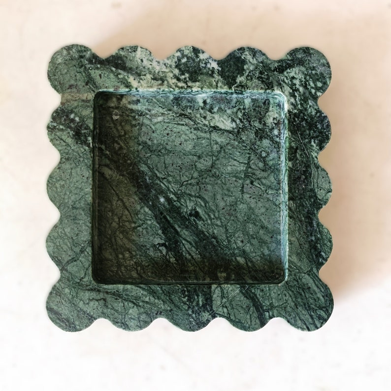 May include: A green marble tray with a scalloped edge. The tray has a square inner section.