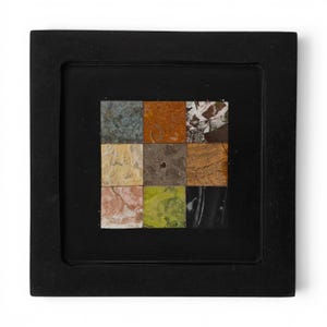 May include: A square black frame containing a grid of nine distinct stone tiles. The tiles feature varied natural textures and colors, including shades of blue, orange, white, tan, gray, brown, pink, lime green, and black with white veining.