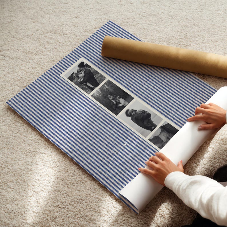 May include: A blue and white striped mat with a series of black and white photographs. A rolled-up white paper and a brown paper tube are also present. The photographs appear to be of people in various poses.