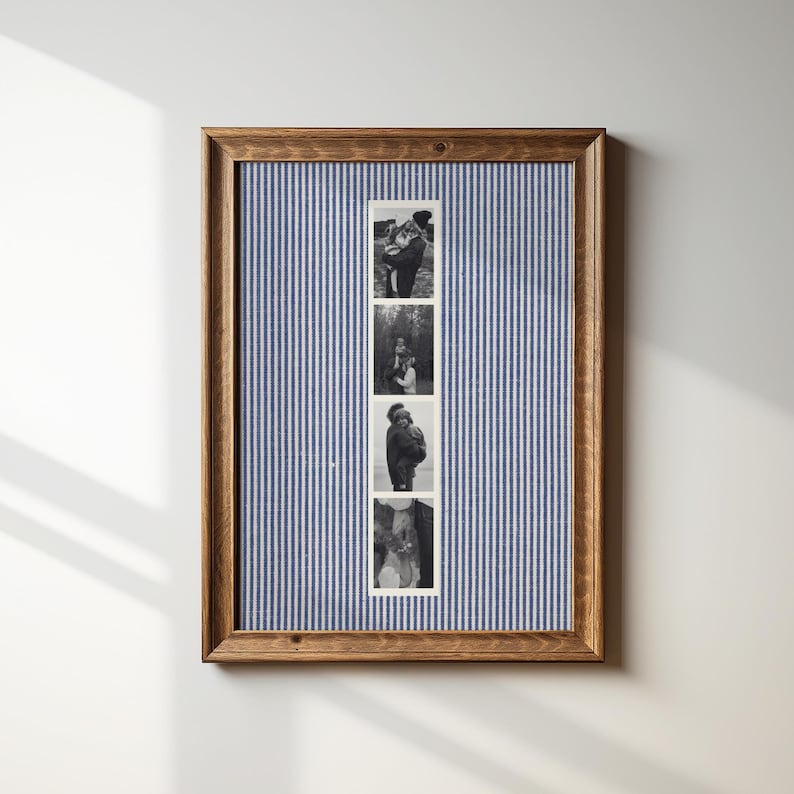 May include: A framed photo display featuring four black and white images. The frame is made of wood and surrounds a blue and white striped fabric background. The photos appear to be of a couple.