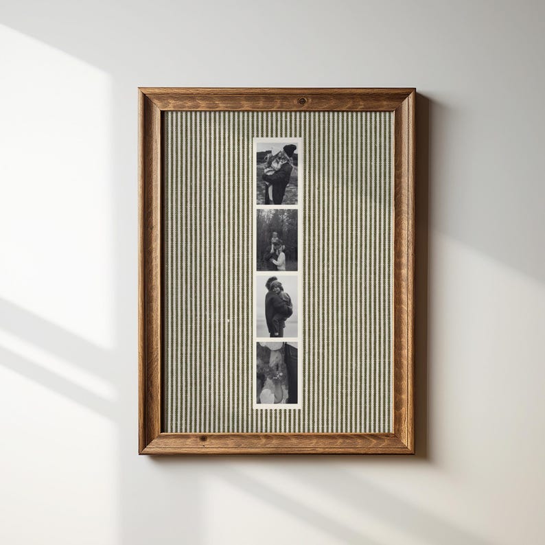 May include: A framed photo display featuring four black and white images. The frame is made of wood with a dark finish. The background is a green and white striped fabric. The photos appear to be of a couple.