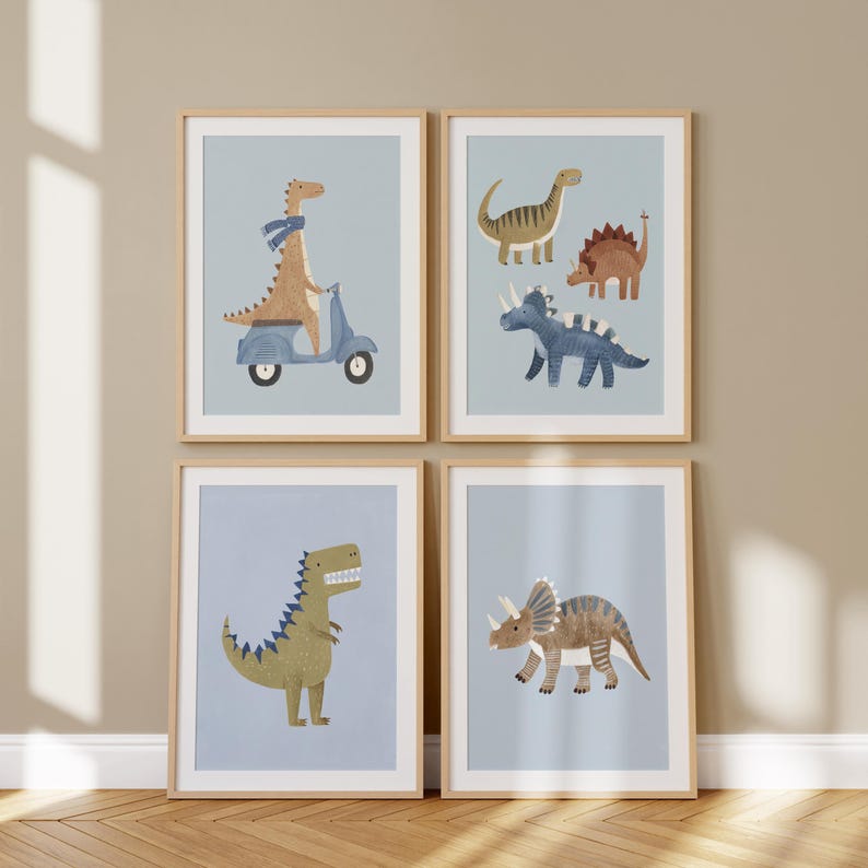 May include: Four framed art prints with dinosaur illustrations. One print shows a dinosaur on a blue scooter. Other prints depict various dinosaurs in brown, blue, and green against a light blue background. The frames are light brown.