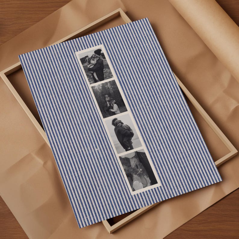 May include: A blue and white striped photo frame with four black and white photographs. The frame is made of wood and sits on a brown paper surface. The photographs appear to be of a couple.