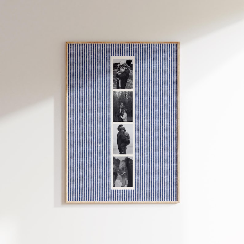 May include: A framed photo display featuring a blue and white striped background. Four black and white photographs are vertically aligned in a white strip. The frame is a light wood color, and the display is mounted on a white wall.
