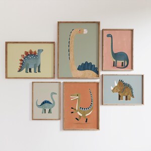 May include: A collection of six framed dinosaur art prints. The illustrations depict various dinosaurs, such as a Stegosaurus and a Triceratops, in a range of colours. The frames are a light brown colour.