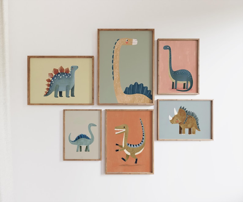 May include: A collection of six framed dinosaur art prints. The illustrations depict various dinosaurs, such as a Stegosaurus and a Triceratops, in a range of colours. The frames are a light brown colour.