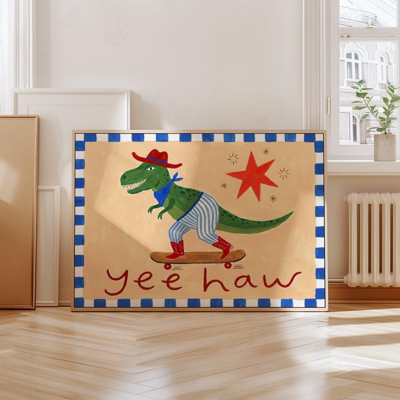 A framed illustration of a dinosaur riding a skateboard, with the text "yeehaw" below the dinosaur.