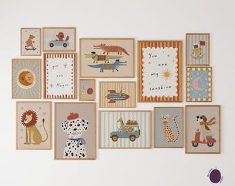 May include: A collection of framed art prints featuring whimsical animal illustrations. The artwork includes a lion, a Dalmatian, a cat, and a dog on a scooter. Some prints have text that reads "You are magic" and "You are my sunshine."