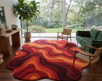 May include: A vibrant, abstract area rug with a unique, organic shape. The rug features a flowing design in shades of red, orange, and yellow, creating a warm and inviting aesthetic. The rug is placed on a dark wood floor.