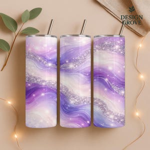 May include: Three stainless steel tumblers with a swirling purple, white, and silver glitter design. Each tumbler has a silver straw and a silver lid. The tumblers are cylindrical and are approximately 20 cm tall.