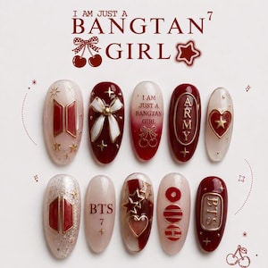 May include: A set of ten press-on nails featuring a deep red and cream color palette. Designs include the text I AM JUST A BANGTAN GIRL, ARMY, and BTS, along with 3D white bows, red hearts, gold stars, and cherry motifs on various glossy surfaces.