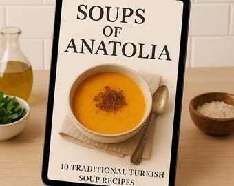 May include: A digital tablet displays the cover of a cookbook titled "Soups of Anatolia." The cover features a bowl of orange soup with a spoon, a small bowl of rice, and a bottle of oil. The text reads "10 Traditional Turkish Soup Recipes."