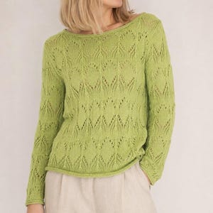 May include: A lime green long-sleeve sweater featuring a delicate openwork knit pattern with repeating leaf-like motifs. The garment has a wide, rounded neckline and a straight hem, crafted from a soft yarn with a visible, textured stitch detail.