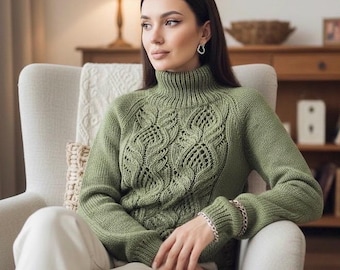 May include: A green turtleneck sweater with a detailed openwork design on the front. The sweater has long sleeves and a ribbed collar. The person is wearing a silver bracelet. The sweater is a soft green color.
