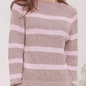 May include: A knitted jumper with horizontal stripes in light brown and pink. The jumper has a round neckline and long sleeves. The soft, textured knitwear is a comfortable garment for casual wear.