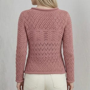 May include: A dusky pink knitted jumper featuring a diamond pattern. The long-sleeved jumper has a round collar and a fitted shape. The back view showcases the intricate openwork design, ideal for a cosy and stylish appearance.