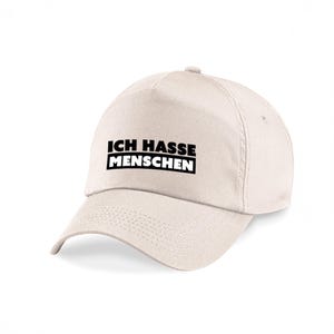 Può includere: Cappellino da baseball color crema con la scritta tedesca "ICH HASSE MENSCHEN" in lettere nere. Il cappellino ha una visiera curva e una corona strutturata, adatto per l'uso quotidiano.