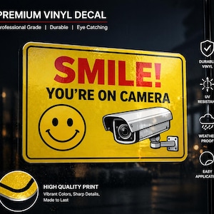May include: A yellow vinyl decal with the text "SMILE! YOU'RE ON CAMERA" in red and black. It features a smiley face and a security camera illustration. The decal is durable, UV resistant, weather proof, and easy to apply.