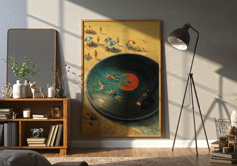 May include: A framed art print depicts a beach scene with people swimming in a vinyl record. The artwork features a sandy beach with umbrellas and swimmers in the water, with a record player needle in the image.