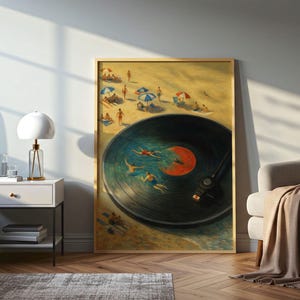 May include: A framed art print depicts a beach scene with a vinyl record design. The record's center label is orange, and swimmers are in the water. The beach has people, umbrellas, and a sandy shore. The artwork is displayed in a room with a lamp and chair.