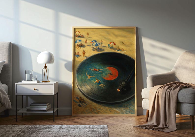 May include: A framed art print depicts a beach scene with a vinyl record design. The record's center label is orange, and swimmers are in the water. The beach has people, umbrellas, and a sandy shore. The artwork is displayed in a room with a lamp and chair.