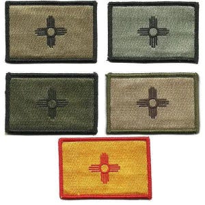 May include: Five rectangular patches featuring the New Mexico Zia symbol. The patches are in various colors, including olive green, tan, and yellow, with the Zia symbol in contrasting colors. Each patch has a black or red border.