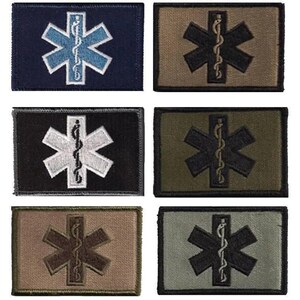 May include: A collection of six rectangular patches featuring the Star of Life symbol. The patches come in various color combinations, including navy blue, black, olive green, and tan, with the star and staff of Asclepius in contrasting colors.