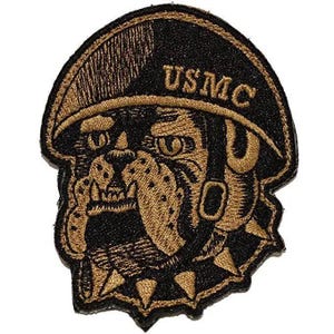 May include: An embroidered patch featuring a bulldog wearing a military helmet with the text USMC printed in gold thread. The design uses a black and gold color scheme, depicting the dog's face with a spiked collar and a helmet strap.