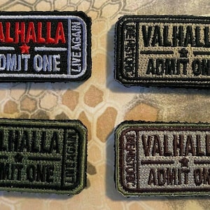 May include: Four rectangular embroidered patches with the text "VALHALLA ADMIT ONE" in various colors. The patches also include the phrases "DIE HISTORIC" and "LIVE AGAIN". The patches are black, olive green, and tan.