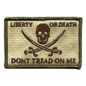 May include: A rectangular embroidered patch in tan and dark brown. The design features a central skull above two crossed swords. The text LIBERTY OR DEATH is printed above the skull, and DONT TREAD ON ME is printed below the skull in dark brown.