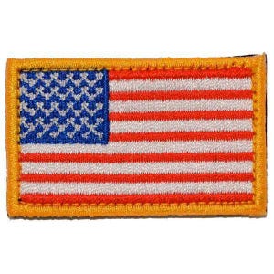 May include: A rectangular embroidered patch featuring the United States flag design. The patch has a blue canton with white stars, alternating red and white horizontal stripes, and a thick, solid gold-colored border surrounding the entire edge.