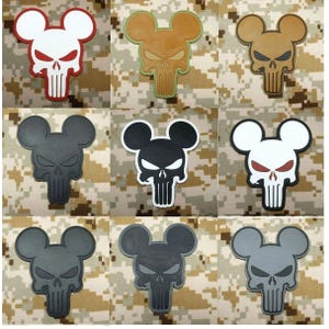 May include: A collection of nine patches featuring a stylized skull design with rounded ears. The patches vary in color, including white, tan, brown, black, and gray, with some featuring contrasting outlines or red accents on the eyes and nose.