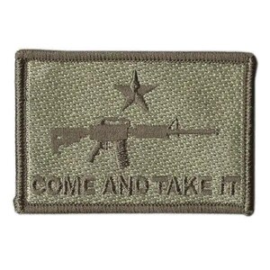 May include: A rectangular olive drab embroidered patch featuring a centered rifle graphic positioned below a single star. The text "COME AND TAKE IT" is stitched in a matching olive thread along the bottom edge of the patch, which has a dark border.