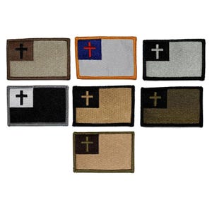 May include: A collection of rectangular patches featuring a cross design. The patches have a flag-like appearance, with a cross in the corner and a solid color field. Colors include black, white, tan, and olive green.