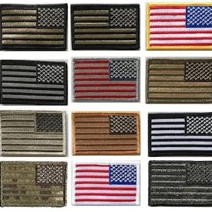 May include: A collection of embroidered American flag patches in various color schemes. The patches feature the stars and stripes design, with variations including olive drab, black and white, and traditional red, white, and blue.