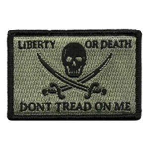 May include: A rectangular olive green embroidered patch with a black border. The design features a central black skull above two crossed swords. The text LIBERTY OR DEATH is printed above the skull, and DONT TREAD ON ME is printed below.