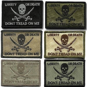 May include: Rectangular patches with the phrases "LIBERTY OR DEATH" and "DONT TREAD ON ME". Each patch features a skull, crossed swords, and text in a variety of colors including black, olive green, and tan.