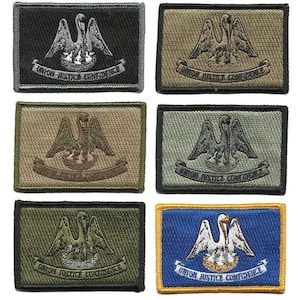 May include: Rectangular embroidered patches featuring a pelican with outstretched wings, a nest, and the text "UNION JUSTICE CONFIDENCE." Patches come in various colors, including black, olive green, tan, and blue with yellow trim. These patches are likely for clothing or accessories.