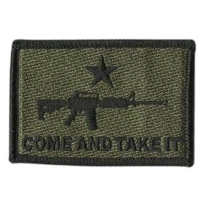 May include: A rectangular olive green embroidered patch with a black border. The design features a black silhouette of a rifle centered below a black star. The text "COME AND TAKE IT" is embroidered in black capital letters along the bottom edge.