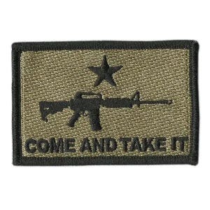 May include: A rectangular olive green embroidered patch with a black border. The design features a black star above a black rifle silhouette, with the text "COME AND TAKE IT" embroidered in black capital letters along the bottom edge.