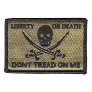 May include: A rectangular embroidered patch in tan with a black border. The design features a central black skull above two crossed swords. The text LIBERTY OR DEATH is printed above the skull, and DONT TREAD ON ME is printed below the swords.
