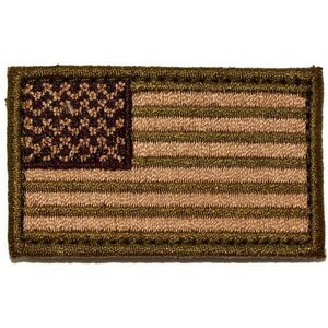 May include: A rectangular embroidered patch featuring a stylized American flag design in monochromatic shades of olive green and dark brown. The patch has a stitched border and displays the flag's stars and stripes pattern in a muted, tactical color scheme.