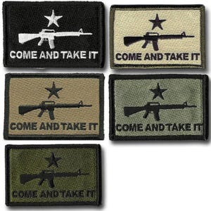 May include: Rectangular patches in black, tan, and olive green, each featuring a star above a rifle and the text "COME AND TAKE IT" in white. The patches are embroidered.