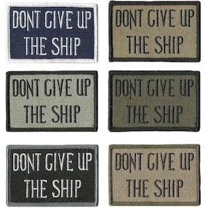 May include: Six rectangular embroidered patches with the text "DONT GIVE UP THE SHIP" in white or gray lettering. The patches are in various colors, including navy blue, olive green, and black.